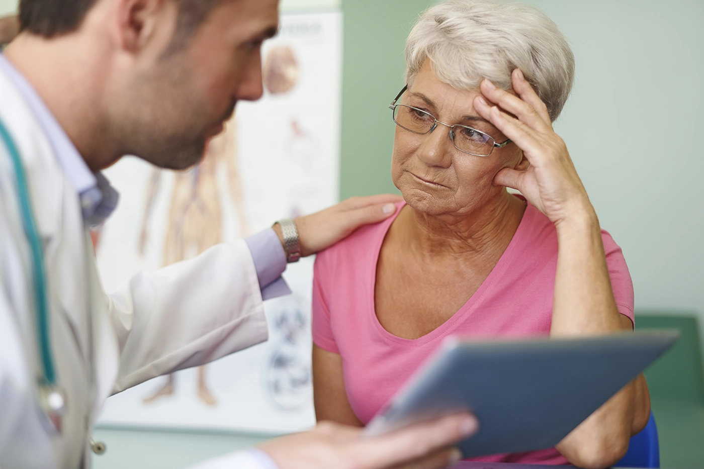 Senior woman consulting doctor about migraine treatment options.