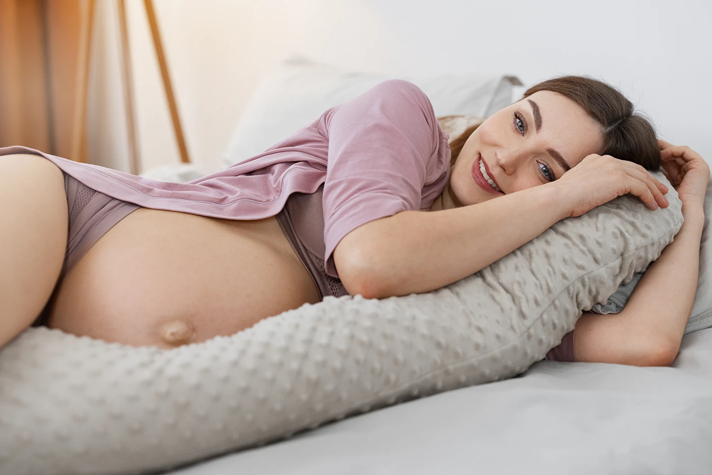 relaxed pregnant woman resting with support pillow during pregnancy and prenatal care in Barrie