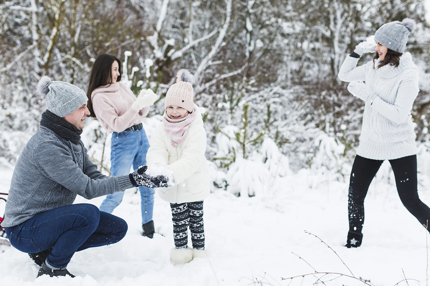 Family having a snowball fight with awareness of typical injuries from winter by Blair Chiropractic & Massage Therapy