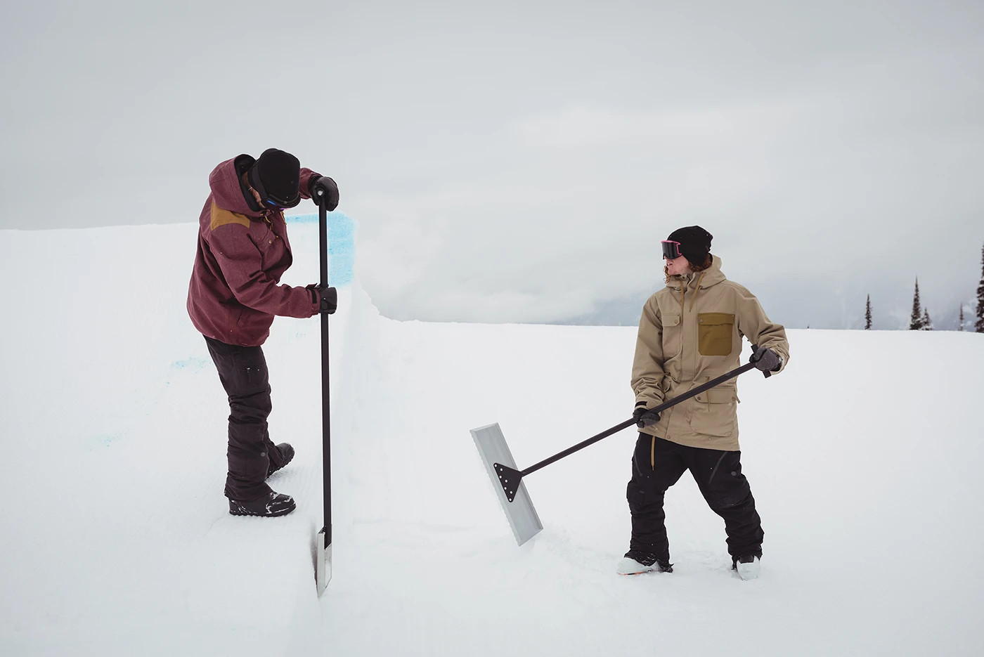 Two people maintaining snow terrain for snow shovelling safety by Blair Chiropractic & Massage Therapy